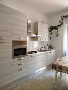 a kitchen with white cabinets and a sink at Casa Bianca in Iglesias