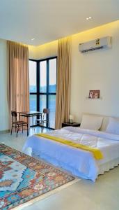 a bedroom with a bed and a table with chairs at Orchid vila in Salalah