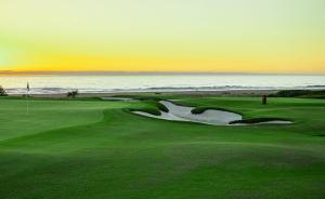 a golf course with the ocean in the background at Beach Condo - 2 Mins from Ocean in Tangier