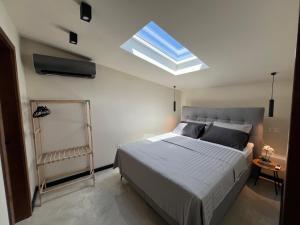 a bedroom with a large bed and a skylight at Villa Central in Crikvenica