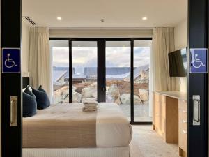 a bedroom with a large bed and a large window at Rabbiters Run - Lake Tekapo in Lake Tekapo +10 photos