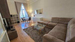 a living room with a couch and a table at Fountain Residence in Sopron