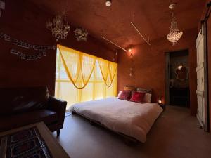 a bedroom with a large bed and a window at villa Morocco in Nagasaki