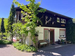 a house with a bench in front of it at Am Damwildgehege I in Oberveischede