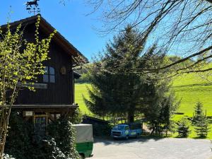 a blue truck parked in front of a house at Am Damwildgehege I in Oberveischede +4 photos