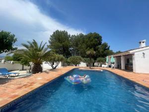 a swimming pool with two inflatables in a backyard at Hotel Casa Pedro Barrera in Almudema