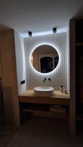 a bathroom with a sink and a mirror at Las Campanas de la Catedral Suite Jacuzzi in Burgos +12 photos
