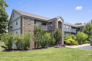 an apartment building with a lawn in front of it at Silver Linings at Pointe Royale in Branson