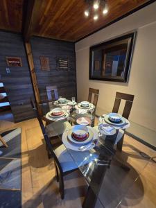 a dining room with a glass table and chairs at Los Camperos AR in Temuco