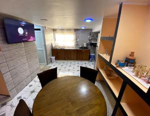 a dining room with a table and a kitchen at Adem s1 in 'Aïn el Turk