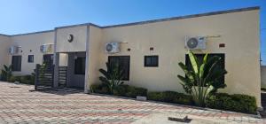 a building with two doors and a courtyard at Dunslim Apartments in Lusaka
