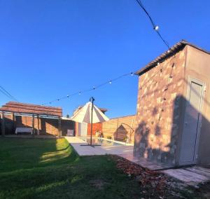 a view of a brick building with a tent in the background at La FRANCESCA in Reconquista