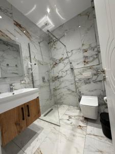 a bathroom with a sink and a toilet at Azure Waves in Vlorë
