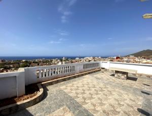 een balkon met een bank en uitzicht op de stad bij Adem s6 in 'Aïn el Turk