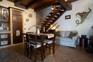 a living room with a table and a couch at Jubilee Antica Borghese 20 minutes from Rome in Mentana