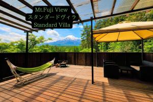 a hammock on a deck with a view of a mountain at Altitude -アルティチュード-939 富士山の麓グランピング in Fujiyoshida