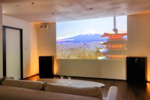 a room with a couch and a view of a mountain at Altitude -アルティチュード-939 富士山の麓グランピング in Fujiyoshida