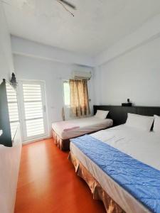Postel nebo postele na pokoji v ubytování Lanyu Gulu Homestay