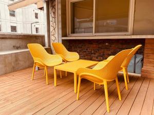 four chairs and a yellow table on a deck at Luxury for family, terrace, 3room,2bath,metro 1min in Seoul