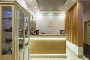 a shop with a counter with a sign on the wall at Corona Hotel & Apartments in Odesa