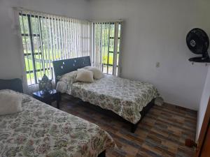 Postel nebo postele na pokoji v ubytování Finca Villa Claudia, La Mesa, Cundinamarca
