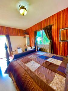 a bedroom with a large bed with wooden walls at Pousada Altitude 1200 in Fazendinha +96 photos