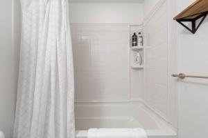 a bathroom with a bath tub with a shower curtain at Designer 3B3B in Capitol Hill Pet Friendly in Seattle +35 photos