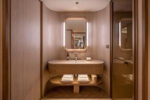 a bathroom with a sink and a mirror at Orange Crystal Beijing Capital Airport New International Exhibition Hotel in Beijing +27 photos