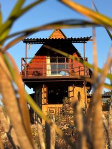 a building with a deck on top of it at Cabana no coração do cerrado in Alto Paraíso de Goiás +7 photos