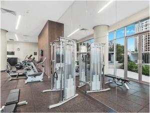 a gym with several exercise equipment in a room at 5 star 3 Bedroom Apt on Surfers Paradise Beach, Ocean views from every room in Gold Coast