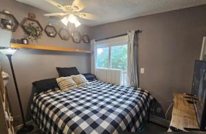 a bedroom with a bed and a ceiling fan at Last Frontier Lodge - Forest, Mountain, Ocean Views in Kodiak