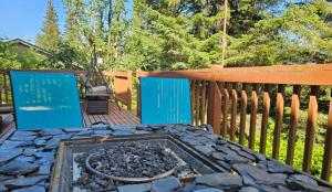 a patio with a fire pit on a wooden fence at Last Frontier Lodge - Forest, Mountain, Ocean Views in Kodiak
