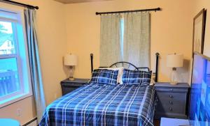 a bedroom with a bed and two dressers and a window at Last Frontier Lodge - Forest, Mountain, Ocean Views in Kodiak +2 photos
