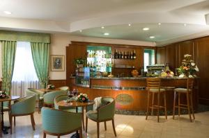 a restaurant with tables and chairs and a bar at Hotel Castle in Rome