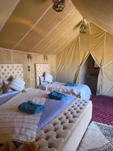 a bedroom with two beds in a tent at Desert luxury tents in Merzouga