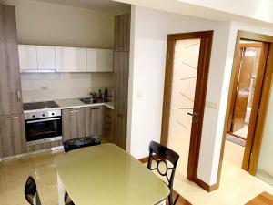 a kitchen with a table and a table and chairs at CENTRAL apartment in Podgorica