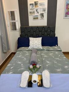 a bedroom with a bed with a black headboard at Brittany Bliss Staycations at SMDC HOPE RESIDENCES in Trece Martires