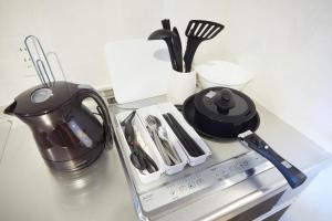 a counter top with a tea kettle and utensils at SG Premium KASAI - Vacation STAY 44353v in Tokyo +7 photos