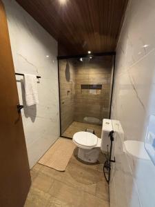 a bathroom with a toilet and a shower at Casa Manari in Jericoacoara +45 photos