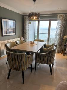 a dining room with a table and chairs at Prime Port Apartment in Portstewart