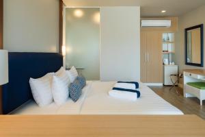a bedroom with a bed with two pillows on it at Phuket Boat Quay Hotel Panwa Beach in Panwa Beach +70 photos