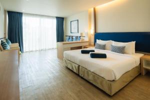 a large bedroom with a large bed in a room at Phuket Boat Quay Hotel Panwa Beach in Panwa Beach