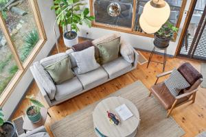 an overhead view of a living room with a couch and a table at CHALET MOMA Port Elliot - BYO Linen - for lovers of different in Port Elliot