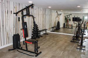a gym with several tread machines in a room at Auroras apartment in Santiago