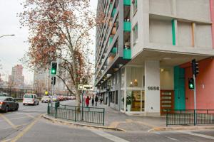 a green traffic light in front of a building at Auroras apartment in Santiago