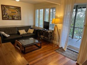 a living room with a couch and a table at Wenlock in Sydney