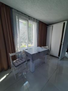 a room with a table and a chair and a window at Weekender - guest house in Kobuleti