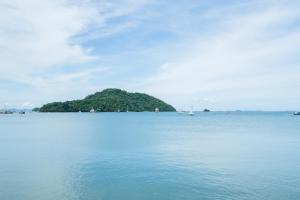 an island in the middle of a large body of water at Phuket Boat Quay Hotel Panwa Beach in Panwa Beach