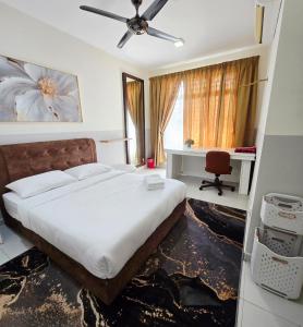a bedroom with a bed with a ceiling fan and a desk at Homestay DAR AL - JUFRY in Kuantan
