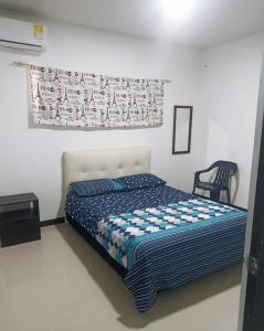 a bedroom with a bed and a poster on the wall at Casa Amoblada Por Días in Tauramena